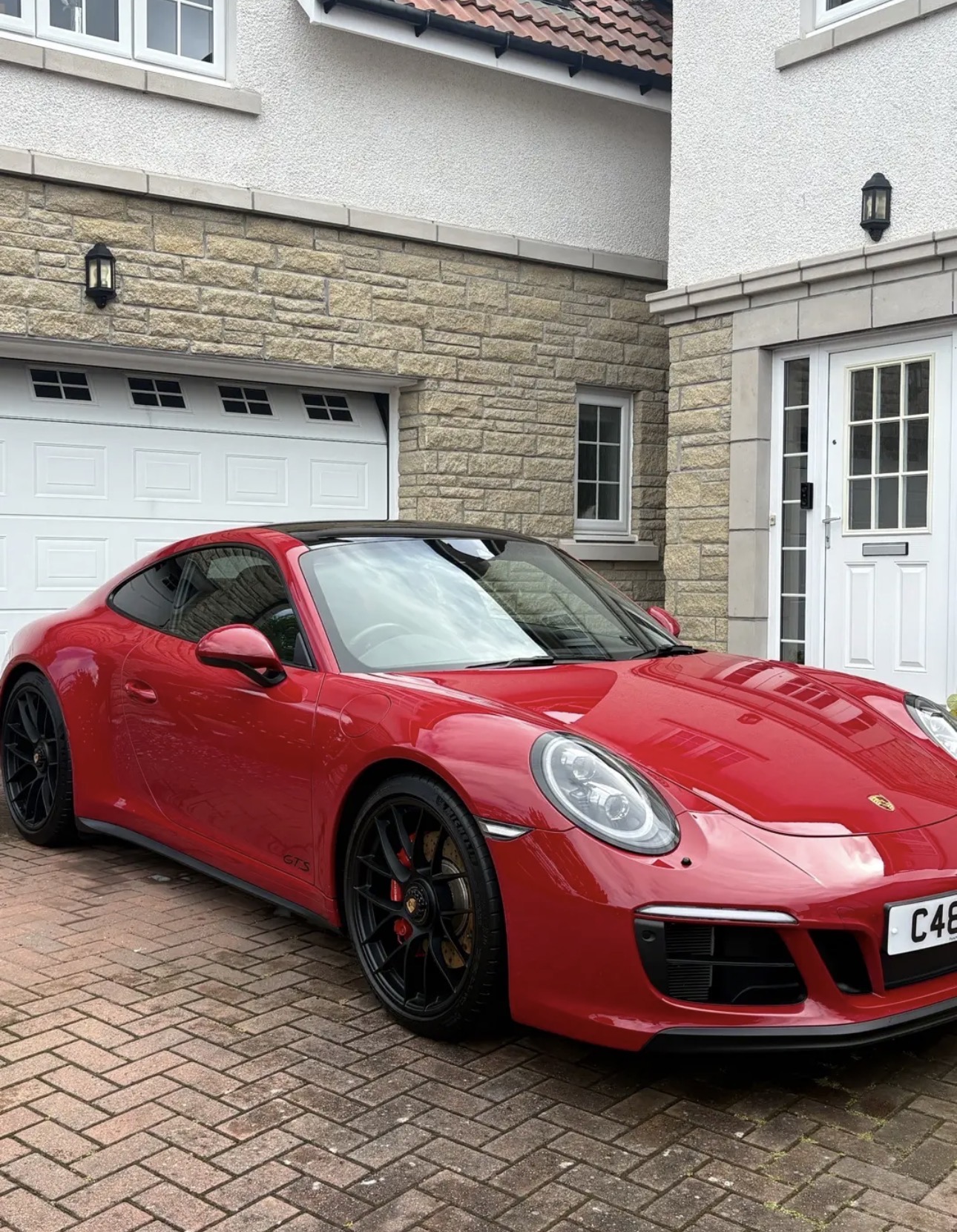 Glossy red Porsche after exterior detailing